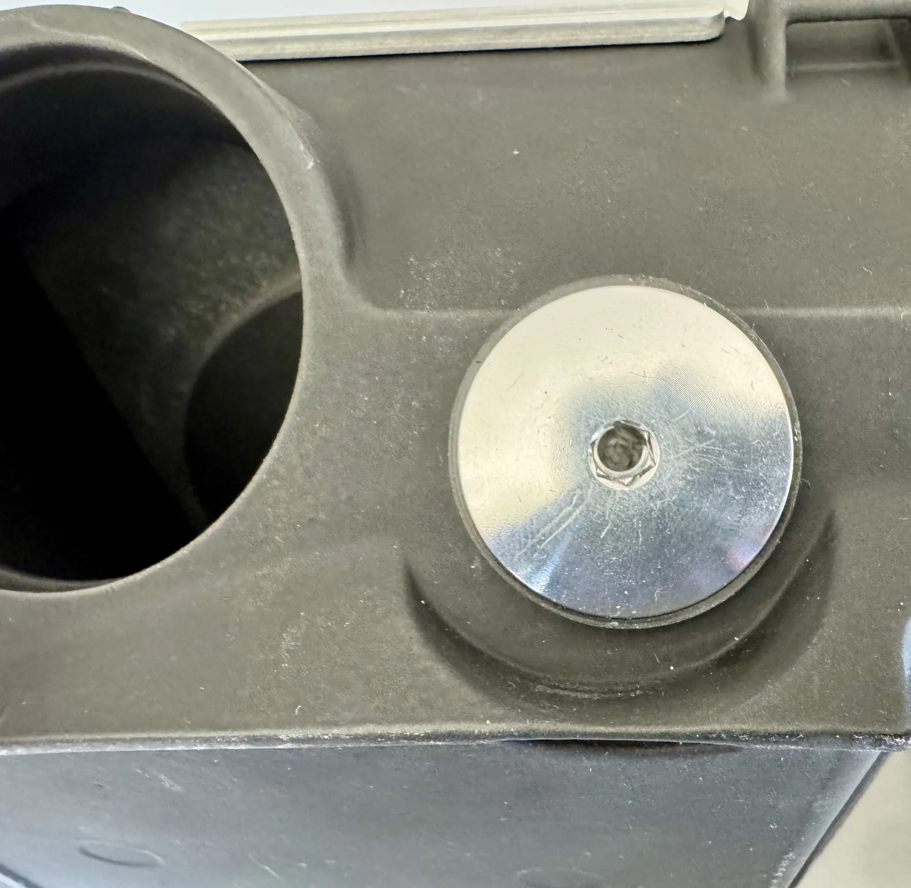 Close-up of a prototype fastener interface on the lower airbox pan