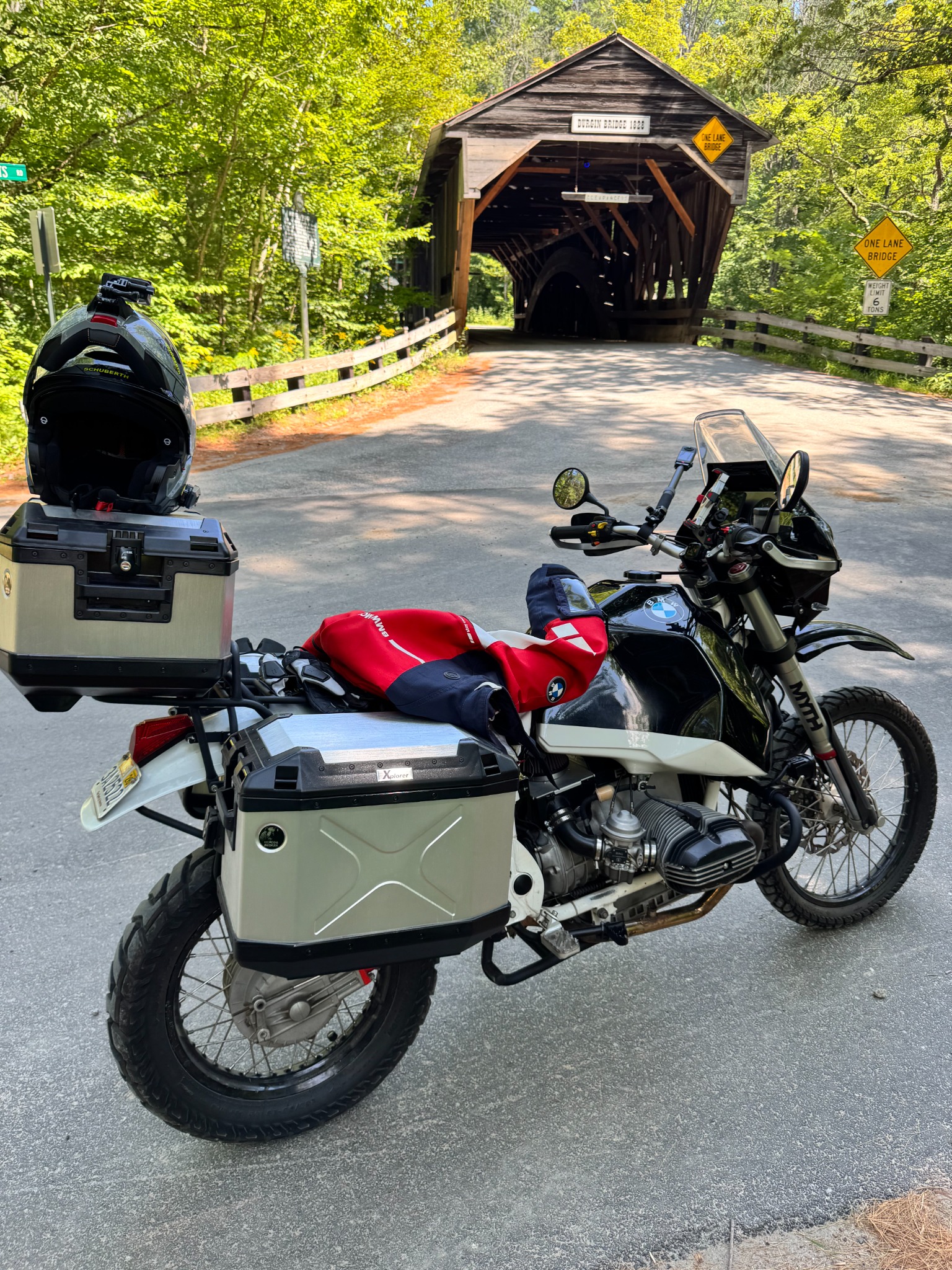 Black and white BMW R80ST parked in front of the wooden Durgin covered bridge